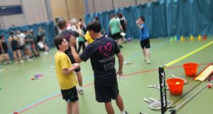 young leader speaking with a coach in a sports hall