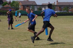 two young people playing cricket