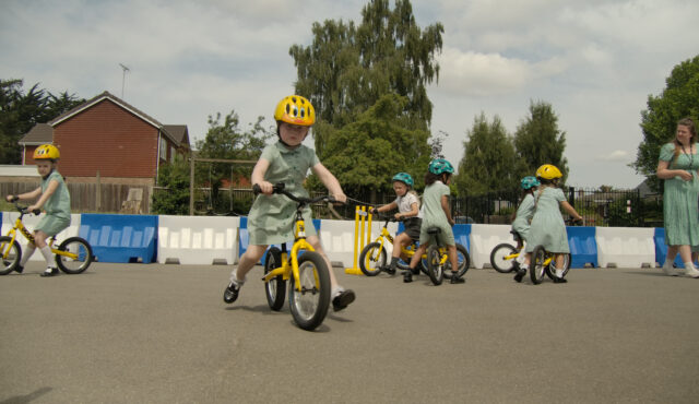 young person on a bike in a playground