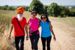 three people walking through a field