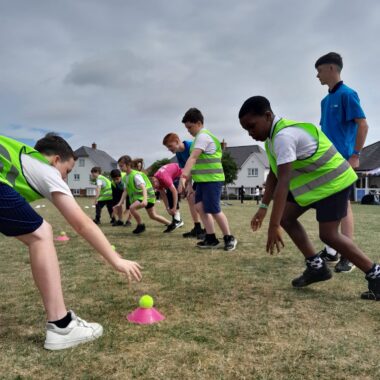 young people playing sport on a field
