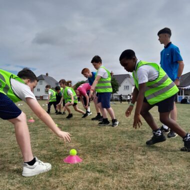 young people playing sport on a field