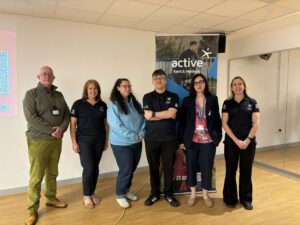 6 people standing infront of a banner that says active kent & medway